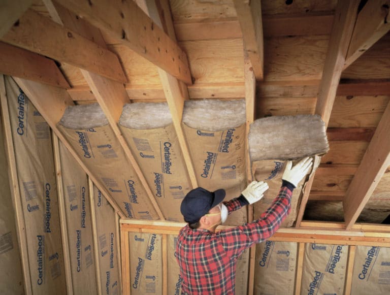 man putting up insulation