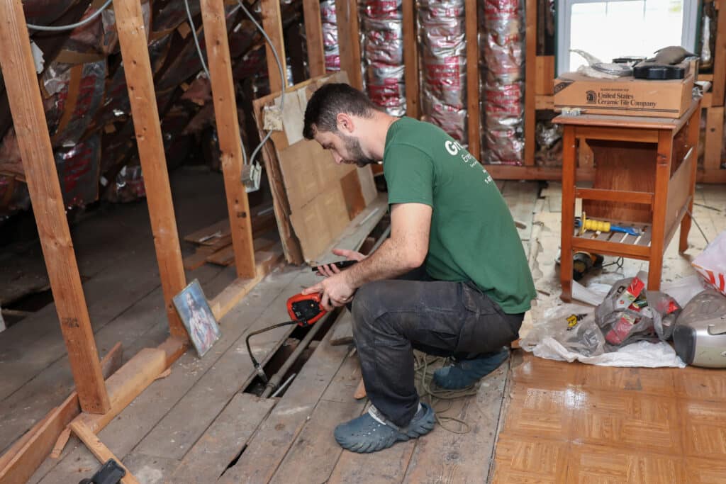GreenLife employee installing insulation