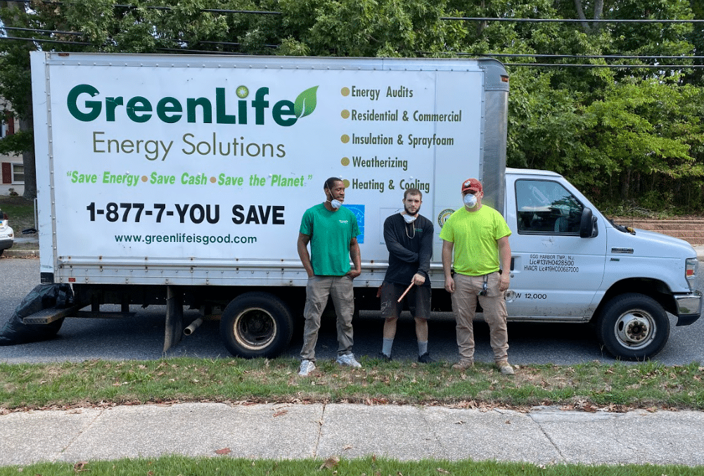 three team members in front of a greenlife truck